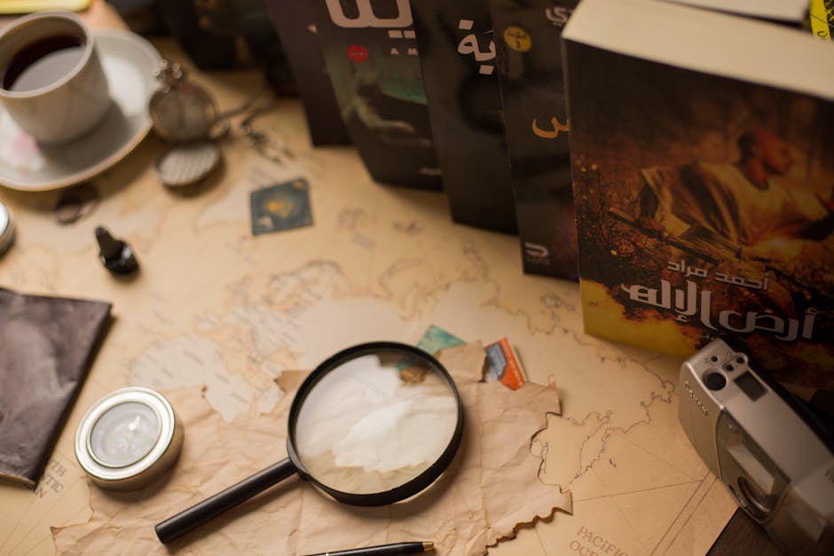 A cozy vintage desk with Arabic novels, magnifying glass, and antique compass.