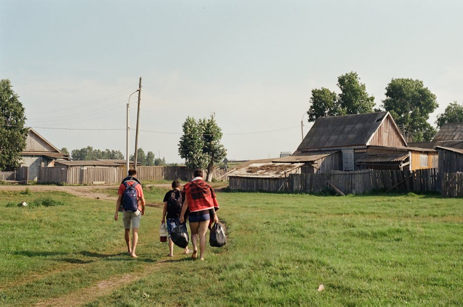 A group walking in a rural village in Buryatia, Russia on a sunny day.